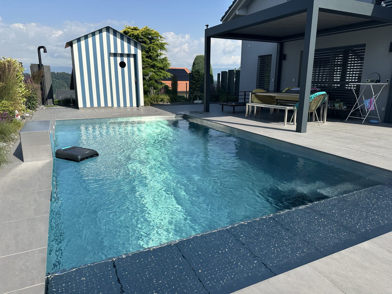 Crystal-clear water of the stainless-steel pool in broad daylight