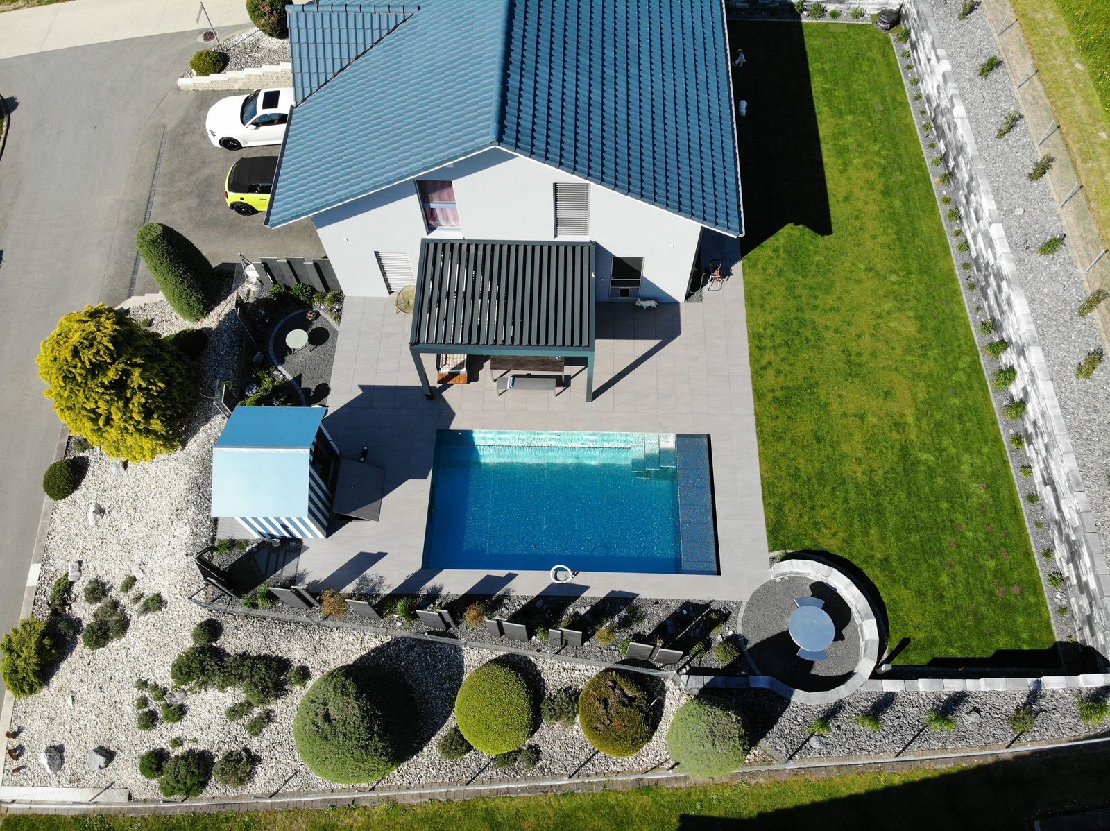 Aerial drone view of the villa, the stainless-steel pool and the landscaped garden